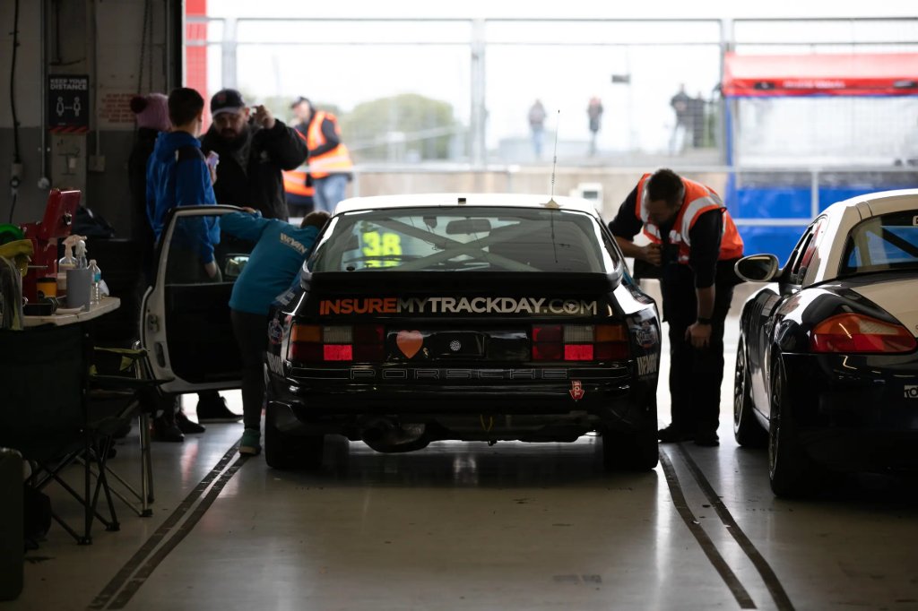 Track day car in the pit garage with its crew